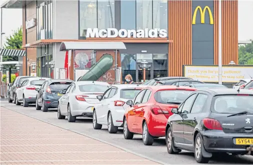  ??  ?? POPULAR: Hungry motorists queueing up at the Inverness Inshes restaurant which was among those in the north to reopen its drive-thru