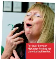  ??  ?? Pet lover Bernann McKinney holding her cloned pitbull terrier.