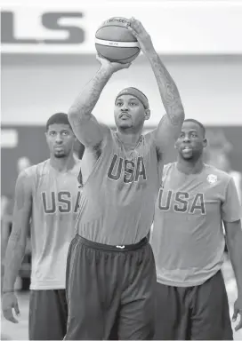  ?? ETHAN MILLER/GETTY IMAGES ?? Team USA’s Carmelo Anthony, who shoots in front of Paul George, left, and Draymond Green, has been one of the most socially conscious players in the NBA.