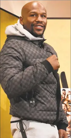  ?? Toshifumi Kitamura / AFP / Getty Images ?? U.S. boxing superstar Floyd Mayweather Jr. poses for the media during a press conference at a Tokyo hotel on Saturday. Mayweather will fight against Japanese kickboxer Tenshin “Ninja Boy” Nasukawa in Saitama in an exhibiton boxing match on Monday.