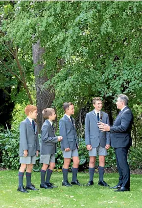  ??  ?? Headmaster Ian Macpherson talks with some of his pupils at Medbury School.