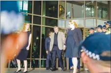  ?? AP PHOTO ?? Australian Cardinal George Pell, centre, departs an Australian court surrounded by police. The alleged victims of the most senior Vatican official ever charged in the Catholic Church sex abuse crisis began giving secret evidence to an Australian court...