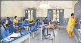  ?? ?? Students follow Covid-19 protocols while attending a class at Government High school in Telangana on Tuesday.