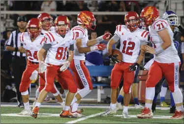  ?? BEA AHBECK/NEWS-SENTINEL ?? Lodi's Andreas Pappas celebrates his catch with his teammates during their non-conference game against Bear Creek in Stockton on Sept 21.