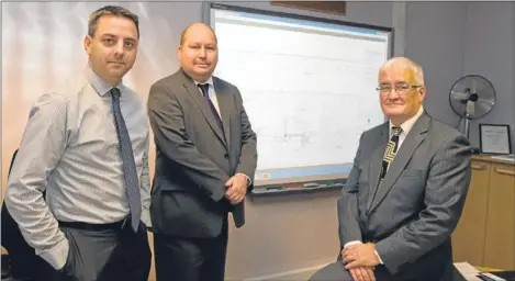  ??  ?? From Left: Derek Davidson, senior engineer; Chic Haggart, roads manager; and John Kellas with the plans for the bridge.