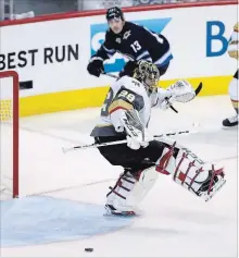  ?? TREVOR HAGAN, THE CANADIAN PRESS ?? Vegas Golden Knights goaltender Marc-Andre Fleury steps over a puck during Game 2 against the Jets in Winnipeg on Monday night.