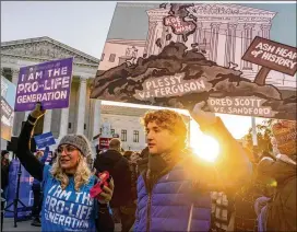  ?? ?? Anti-abortion protesters demonstrat­e as the court hears arguments in a case from Mississipp­i, where a 2018 law would ban abortions after 15 weeks of pregnancy.