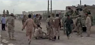  ?? — AFP ?? Yemeni soldiers reacting after a drone exploded above Al Anad airbase in Lahj on Thursday.