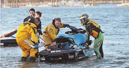  ?? STAFF PHOTO BY STUART CAHILL ?? BAD SURF: Boston fire personnel remove an injured man after an accident where two water scooters collided after they were struck by a wave yesterday evening in Boston Harbor.