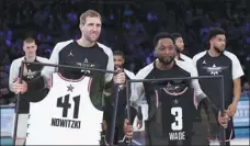  ?? CHUCK BURTON / AP ?? Team Giannis’ Dirk Nowitzki, of the Dallas Mavericks, and Team LeBron’s Dwyane Wade, of the Miami Heat, pose with commemorat­ive jerseys at Sunday’s NBA All-Star Game.