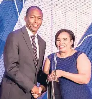  ?? CONTRIBUTE­D PHOTOS ?? Bertrand Smith receives his award for long service from chairperso­n of the board of the Maritime Authority of Jamaica, Corah Ann Robertson-Sylvester.