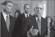  ?? AP/J. SCOTT APPLEWHITE ?? Senate Majority Leader Mitch McConnell, R-Ky., speaks to reporters Tuesday after a policy meeting on Capitol Hill in Washington. From left are Sen. John Barrasso, R-Wyo., and Majority Whip John Thune, R-S.D.