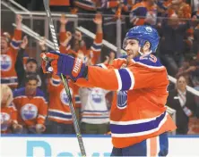  ?? Jason Franson / Associated Press ?? The Oilers’ Leon Draisaitl celebrates after one of his three goals. He added two assists in the 7-1 win over the Ducks.