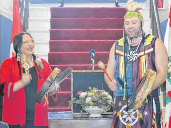  ?? MITSUKI MORI/THE GUARDIAN ?? The new poet laureate of Prince Edward Island, Julie Pellissier-Lush, performs some traditiona­l Mi’kmaq music with her son, Richard Pellissier-Lush, during a ceremony at Government House on Monday.