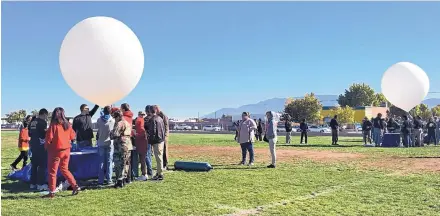  ?? MADDY HAYDEN/JOURNAL ?? A high-altitude balloon launch team from Ernie Pyle Middle School, left, prepares to release their balloon Tuesday morning at West Mesa High School during the Near Space Challenge. The competitio­n ended Wednesday.