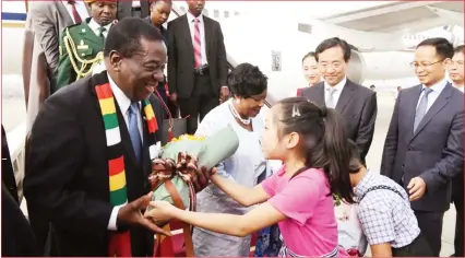  ??  ?? President Mnangagwa receives a bouquet of flowers as he and First Lady Auxillia Mnangagwa are welcomed by Chinese officials at the Beijing Internatio­nal Airport ahead of the 7th Forum on China-Africa Cooperatio­n (FOCAC) Summit in China yesterday.