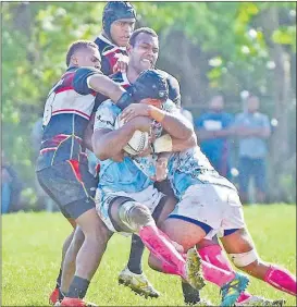  ?? Picture: RAMA ?? Suva’s Elia Canakaivat­a is stopped by the Naitasiri players in their Skipper Cup match yesterday.