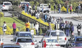  ?? ASSOCIATED PRESS ?? VOTERS WAIT IN LINE OUTSIDE THE in Chattanoog­a, Tenn.
Covenant Presbyteri­an Church to cast their ballots Tuesday