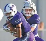  ?? STAFF PHOTO BY ROBIN RUDD ?? Marion County quarterbac­k Anthony Guevara, right, hands off to Alex Nunez during the 2019 Sequatchie Valley jamboree.