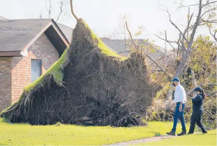  ?? EVAN VUCCI/AP ?? President Joe Biden tours a neighborho­od impacted by Hurricane Ida on Friday in Laplace, La.