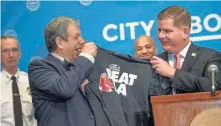  ?? FAITH NINIVAGGI / BOSTON HERALD ?? T FOR YOU: Mitchell Modell, left, CEO of Modell’s Sporting Goods, gives a ‘Beat LA’ T-shirt, to Mayor Martin J. Walsh yesterday. A portion of the proceeds from sales of the shirt will benefit homeless veterans.