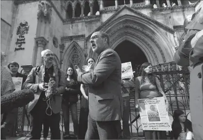  ?? Associated Press ?? n The Rev. Patrick Mahoney from Washington, D.C., center, speaks to the media outside the Royal Courts of Justice in London as he joins other Charlie Gard supporters. Protesters who want critically ill British baby Charlie Gard to receive an...