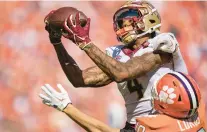  ?? JACOB KUPFERMAN/AP ?? Florida State wide receiver Keon Coleman catches what turned out to be the game-winning touchdown pass while covered by Clemson cornerback Jeadyn Lukus on Saturday.