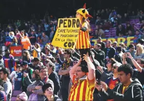  ?? GETTY IMAGES ?? FC Barcelona supporters cheer their team prior to the La Liga match between FC Barcelona and Rayo Vallecano de Madrid at Camp Nou in Barcelona, Spain.