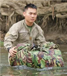  ?? Photo: New Zealand Defence Force ?? Officer Cadet Aaron Chan, a combat engineer from the Singapore Armed Forces, crosses a river during jungle warfare training in Papua New Guinea.