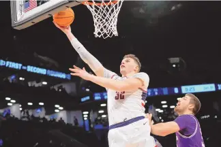  ?? ?? ASSOCIATED PRESS UConn center Donovan Clingan (32) became just the third player in NCAA Tournament history to get 14 points, 14 rebounds and eight blocks during Sunday’s second-round win over Northweste­rn.