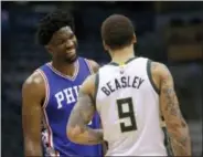  ?? AARON GASH — THE ASSOCIATED PRESS ?? The Sixers’ Joel Embiid, left, going all grins with Milwaukee’s Michael Beasley in a game last Monday, will miss the next two games due to an injury, the Sixers say.