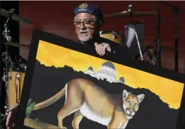  ?? KEITH BIRMINGHAM — SOUTHERN CALIFORNIA NEWS GROUP ?? California state Sen. Anthony Portantino holds of a painting of P-22that he had commission­ed during a celebratio­n of life for the deceased wild mountain lion at the Greek Theatre in Griffith Park in Los Angeles on Saturday.