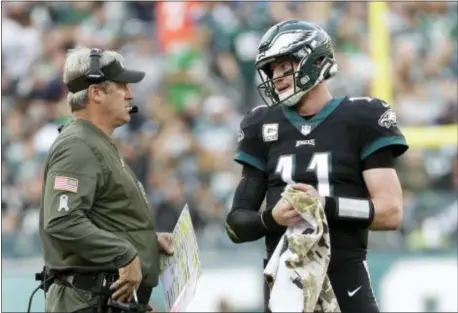  ?? MICHAEL PEREZ — THE ASSOCIATED PRESS ?? With a bye week coming for the 8-1 Eagles, coach Doug Pederson, left, and quarterbac­k Carson Wentz will look to rest up and clean up a few small items.