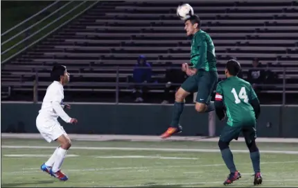  ?? MIKE BUSH/ NEWS-SENTINEL ?? Liberty Ranch's Edurado Landin uses his head to move the ball in front of teammate Salvador Medrano (14) and Tokay's Ivan Rosales in Tuesday's non-league boys soccer game at the Grape Bowl.