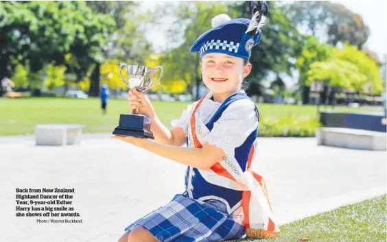  ?? Photo / Warren Buckland. ?? Back from New Zealand Highland Dancer of the Year, 9-year-old Esther Harry has a big smile as she shows off her awards.