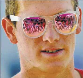  ?? Bill Hughes Las Vegas Review-Journal ?? Young swimmers are reflected in the sunglasses of Zane Grothe while he conducts a swimming clinic for members of the Boulder City-Henderson Heatwave.