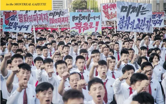  ?? KIM WON-JIN / AFP / GETTY IMAGES ?? North Koreans wave banners and shout slogans as they attend a rally Wednesday in Kim Il Sung Square in Pyongyang in support of their country’s stance against the U.S. Also on Wednesday, President Donald Trump warned the rogue Asian country that the...