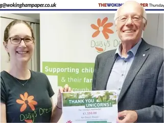  ??  ?? Claire Rhodes, fundraiser at Daisy’s Dream, thanks John Waddelove from Thames Valley Unicorns, for the group’s donation of £1,250 towards the charity’s work