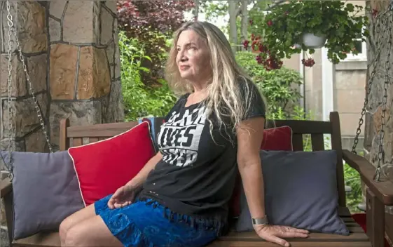  ?? Nate Guidry/Post-Gazette ?? Kimberly Latta sits on her porch in Highland Park. During a social justice protest on June 1 in East Liberty, Ms. Latta said she was gassed, bound by police and told she would be receiving a summons.