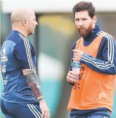  ??  ?? Argentina head coach Jorge Sampaoli talks to Lionel Messi during a training session. — Reuters photo