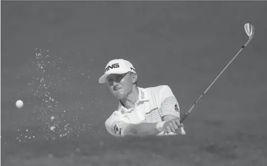  ?? MATT SLOCUM/THE ASSOCIATED PRESS ?? Mackenzie Hughes of Dundas, Ont., hits out of the bunker on the second hole during a practice round for the Masters on Tuesday in Augusta, Ga.