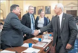  ?? J. SCOTT APPLEWHITE/AP ?? Rep. Dave Reichert, right, reaches out to Minnesota farmer Kevin Paap, who testified Wednesday before a House panel about the effect of foreign tariffs on U.S. agricultur­e.