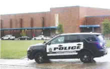  ?? STAFF PHOTO BY ERIN O. SMITH ?? A Chattanoog­a police vehicle blocks the entrance to Brainerd High School on Wednesday. The school was on lockdown for several hours as K-9 units performed a sweep of the interior.