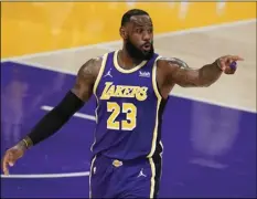  ?? AP PHOTO/MARCIO JOSE SANCHEZ ?? Los Angeles Lakers forward LeBron James signals to a teammate during the first half of an NBA basketball game against the Charlotte Hornets on March 18 in Los Angeles.