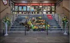  ?? RICHARDS/THE CANADIAN PRESS VIA AP ?? A memorial at the stairs that lead to Elgar Petersen Arena is shown in Humboldt, Saskatchew­an, on Saturday. Royal Canadian Mounted Police say 14 people are dead and others injured Friday after a truck collided with a bus carrying a junior hockey team...