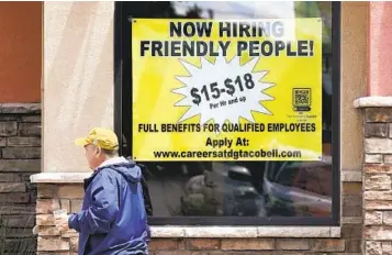  ?? RICH PEDRONCELL­I AP ?? Starting wages are advertised in the window of a Taco Bell in Sacramento this week. Labor shortages have prompted many companies to increase pay beyond the minimum wage to attract and retain workers.