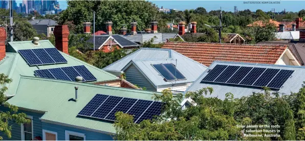  ?? SHUTTERSTO­CK/ADAM CALAITZIS ?? Solar panels on the roofs of suburban houses in Melbourne, Australia