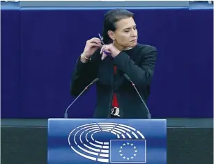  ?? (European Union/handout via Reuters) ?? SWEDISH LAWMAKER Abir Al-Sahlani cuts her hair as she delivers a speech during an EU debate on Iran protests at the European Parliament in Strasbourg, France, yesterday.