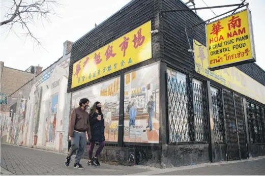  ?? PAT NABONG/SUN-TIMES PHOTOS ?? Hoa Nam, one of a few Asian supermarke­ts in the “Asia on Argyle” neighborho­od, closed early in the pandemic when the owners retired. A mural in the window depicts the different immigrants who settled along West Argyle Street.