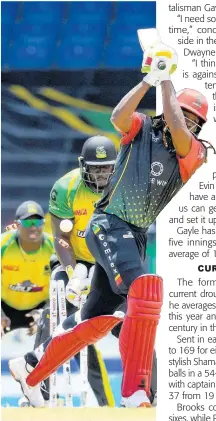 ?? CPL T20/GETTY IMAGES ?? Chris Gayle (right) of Saint Kitts & Nevis Patriots is bowled by Chris Green of Jamaica Tallawahs during the 2021 Hero Caribbean Premier League T20 cricket match at Warner Park Sporting Complex in Basseterre, Saint Kitts and Nevis, yesterday.